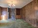 Living room with wood paneling, stone fireplace and built-in shelves at 1074 25Th Ne St, Hickory, NC 28601