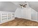 Versatile attic space with built-in shelves, closet, wood-look floors, and a charming dormer window at 109 Arabian Ln, Salisbury, NC 28147