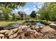Landscaped backyard with a charming pond at 109 Arabian Ln, Salisbury, NC 28147
