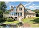 Large, multi-story brick home with outdoor deck and a serene backyard pond at 109 Arabian Ln, Salisbury, NC 28147