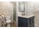 Modern bathroom with marble tile, glass shower, and stylish vanity with a dark blue cabinet at 109 Arabian Ln, Salisbury, NC 28147