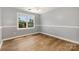 Comfortable bedroom with laminate flooring, neutral paint, and a bright window with natural light at 109 Arabian Ln, Salisbury, NC 28147