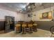 Basement features a bar area with seating, a dartboard, and a mounted television for entertainment at 110 Lakeland Rd # 19, Mooresville, NC 28117