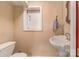 Powder room with pedestal sink, a window and neutral wall color offering a serene and functional space at 110 Lakeland Rd # 19, Mooresville, NC 28117