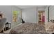 Bedroom with patterned bedding, a desk, and sliding glass doors to a private outdoor deck at 110 Lakeland Rd # 19, Mooresville, NC 28117