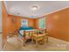 Cozy bedroom with a log-frame bed, orange walls, and two windows providing natural light at 110 Lakeland Rd # 19, Mooresville, NC 28117
