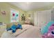 Bright bedroom with large double door closet and a cheerful, youthful decor at 110 Lakeland Rd # 19, Mooresville, NC 28117