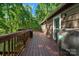 Outdoor deck with railing and grill, perfect for enjoying outdoor dining and a wooded landscape at 110 Lakeland Rd # 19, Mooresville, NC 28117