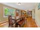 Open concept dining area leading to kitchen, featuring hardwood floors and backyard views at 110 Lakeland Rd # 19, Mooresville, NC 28117