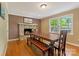 Inviting dining room featuring hardwood floors, stone fireplace, and an abundance of natural light at 110 Lakeland Rd # 19, Mooresville, NC 28117