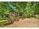 View of a cozy home with a wooden deck, nestled amongst lush greenery and mature trees at 110 Lakeland Rd # 19, Mooresville, NC 28117
