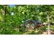 Exterior shot of a home nestled among mature trees showcasing its deck and well-maintained lawn at 110 Lakeland Rd # 19, Mooresville, NC 28117