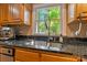Kitchen featuring stainless steel sink, granite countertops, and a view of the backyard at 110 Lakeland Rd # 19, Mooresville, NC 28117