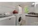 Laundry room with washer, dryer, utility sink, and ample cabinet space for storage at 110 Lakeland Rd # 19, Mooresville, NC 28117