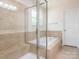 A well-lit bathroom features a stand-up shower, soaking tub, and private commode at 12304 Lookout Point Dr, Charlotte, NC 28269