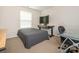 Neutral bedroom with large monitor on an adjustable desk and carpet flooring at 12304 Lookout Point Dr, Charlotte, NC 28269