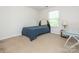 Small carpeted bedroom has a bed, glass desk, and a window at 12304 Lookout Point Dr, Charlotte, NC 28269