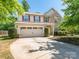 Charming two-story home with a well-manicured lawn and a spacious two car garage at 12304 Lookout Point Dr, Charlotte, NC 28269