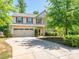 Charming two-story home with a well-manicured front lawn and a two-car garage at 12304 Lookout Point Dr, Charlotte, NC 28269