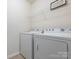 Bright laundry room with modern appliances and overhead storage space at 12304 Lookout Point Dr, Charlotte, NC 28269