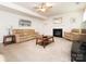 Inviting living room featuring a fireplace, comfortable seating, and a ceiling fan at 12304 Lookout Point Dr, Charlotte, NC 28269