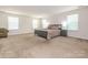 Expansive primary bedroom with lots of natural light, neutral tones, and plush carpeting, creating a peaceful retreat at 12304 Lookout Point Dr, Charlotte, NC 28269