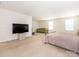Carpeted main bedroom offers expansive layout, seating, and a ceiling light at 12304 Lookout Point Dr, Charlotte, NC 28269