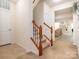 Inviting staircase with wooden banisters and carpeted steps leading upstairs at 12304 Lookout Point Dr, Charlotte, NC 28269