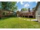 Expansive backyard with mature trees, deck, and well-maintained lawn at 1260 Piccadilly Dr, Charlotte, NC 28211