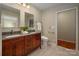 Bathroom featuring double sink vanity with granite counters and wood cabinets at 1260 Piccadilly Dr, Charlotte, NC 28211