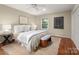 Bright bedroom features a ceiling fan, natural light, and a cozy rug at 1260 Piccadilly Dr, Charlotte, NC 28211