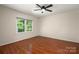 Bedroom featuring hardwood floors, a ceiling fan, and a window with natural light at 1260 Piccadilly Dr, Charlotte, NC 28211