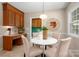 Cozy breakfast nook with round table, upholstered chairs, built-in desk, and wood cabinetry at 1260 Piccadilly Dr, Charlotte, NC 28211