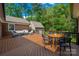 Large wooden deck with ample seating, a dining area, and a well-manicured backyard at 1260 Piccadilly Dr, Charlotte, NC 28211