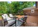 Spacious wooden deck with outdoor seating, a table, and green backyard views at 1260 Piccadilly Dr, Charlotte, NC 28211