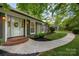 Inviting front entrance featuring a walkway, lush landscaping, and decorative details on the front door at 1260 Piccadilly Dr, Charlotte, NC 28211