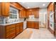 Well-lit kitchen showcases wood cabinets, neutral countertops, a tile backsplash, and a window over the sink at 1260 Piccadilly Dr, Charlotte, NC 28211