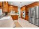 Spacious kitchen features wood cabinets, stainless steel appliances, neutral countertops, and tiled floors at 1260 Piccadilly Dr, Charlotte, NC 28211