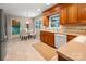 Bright kitchen features wood cabinets, neutral countertops, tile backsplash, and a breakfast nook with a round table at 1260 Piccadilly Dr, Charlotte, NC 28211