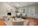 Bright living room with fireplace, neutral furnishings, and large windows for natural light at 1260 Piccadilly Dr, Charlotte, NC 28211