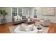 Inviting living room features comfortable seating, a round coffee table, hardwood floors, and natural light at 1260 Piccadilly Dr, Charlotte, NC 28211