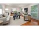 Cozy living room with neutral decor, hardwood floors, and lots of space for entertaining guests at 1260 Piccadilly Dr, Charlotte, NC 28211