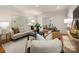 Comfortable living room featuring neutral tones, hardwood floors, and an open layout to the dining area at 1260 Piccadilly Dr, Charlotte, NC 28211