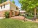 Brick patio is adjacent to the home, looking out to a verdant backyard with mature trees at 1325 Rock Point Rd, Charlotte, NC 28270