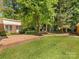 Brick patio and walkway extend into an expansive backyard at 1325 Rock Point Rd, Charlotte, NC 28270
