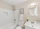 Bathroom with modern fixtures, white tiling, and tub with shower and neutral colored walls at 1325 Rock Point Rd, Charlotte, NC 28270