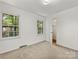 Inviting bedroom features neutral carpeting, two windows, and a closet at 1325 Rock Point Rd, Charlotte, NC 28270