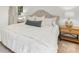 Bedroom showcasing a comfortable bed with a tufted headboard and bedside tables with lamps at 1325 Rock Point Rd, Charlotte, NC 28270