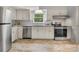 Bright kitchen with white cabinets, stainless steel appliances, and tile backsplash at 1325 Rock Point Rd, Charlotte, NC 28270