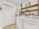 Functional laundry room with modern washer, dryer, shelving, and ample storage space at 1325 Rock Point Rd, Charlotte, NC 28270